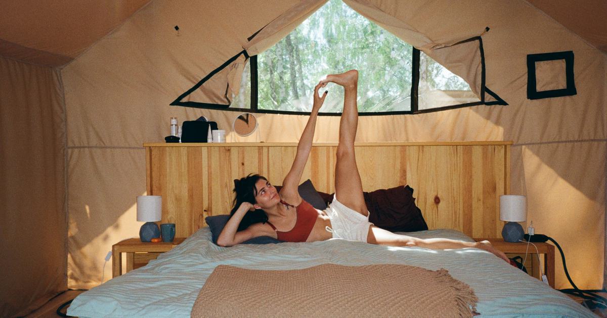 Homme installant un matelas gonflable sur un site de camping